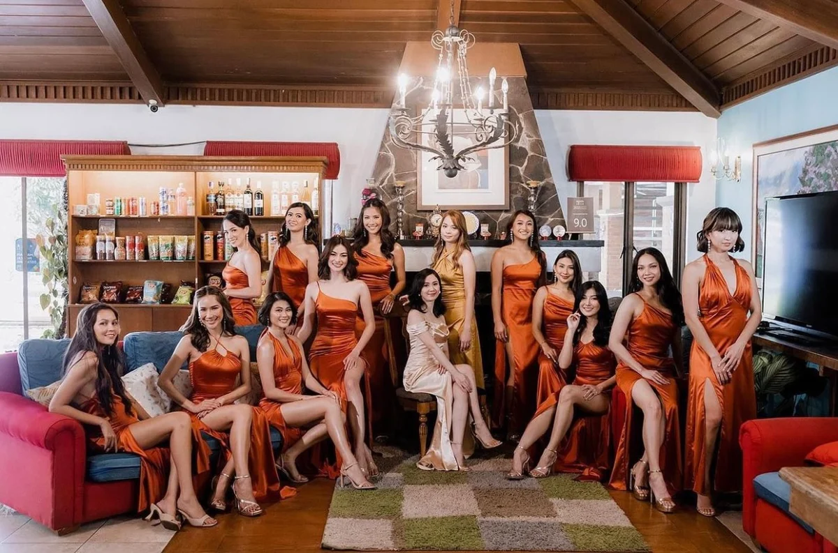 Bridal party in rust satin dresses indoors
