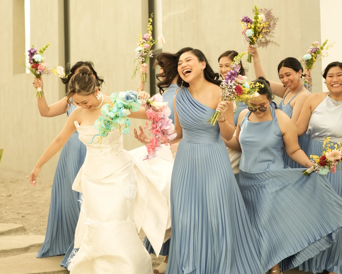 Bride with bridal party in blue dresses celebrating